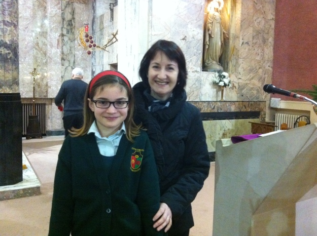 Emmie with her teacher, Ms. Bourke, after the Christmas Carol Service.
