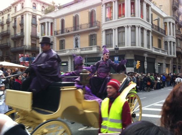Artistically dressed men waved to the crowds in their carriages  
