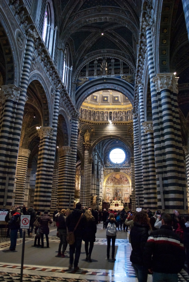 The inside of Siena's Gothic Cathedral with its white and black  striped marble